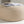 Pouf Sam beige utilisé comme repose-pieds