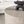 Table basse ronde York beige utilisée comme table basse de salon